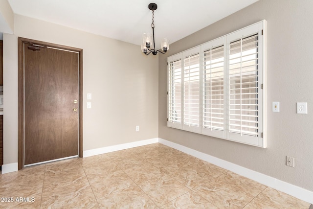 unfurnished room with an inviting chandelier