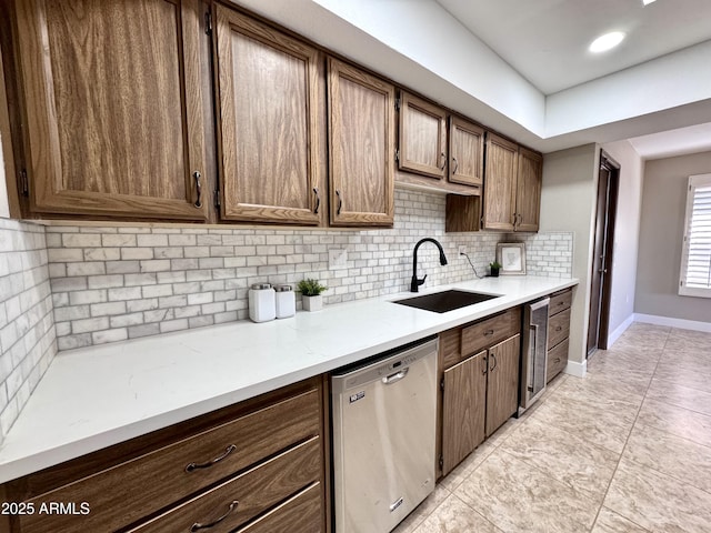 kitchen featuring sink, dishwasher, tasteful backsplash, wine cooler, and light tile patterned flooring