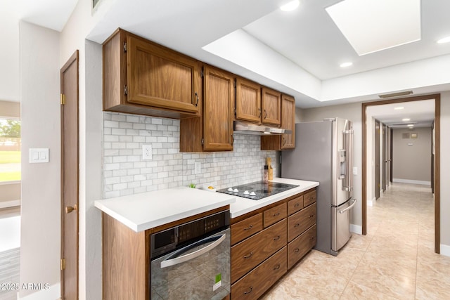 kitchen featuring tasteful backsplash, stainless steel refrigerator with ice dispenser, black electric stovetop, and oven