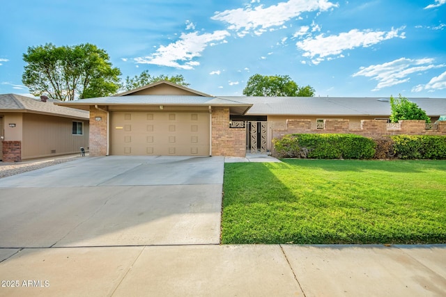 single story home featuring a garage and a front lawn