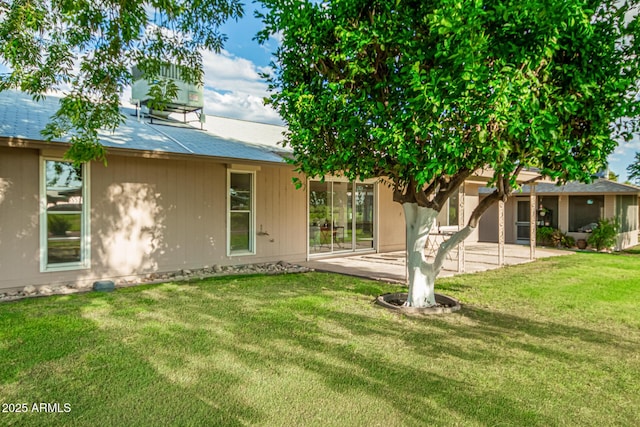 rear view of house with a yard and a patio area