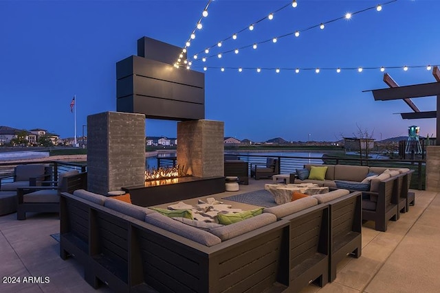 patio terrace at dusk featuring outdoor lounge area