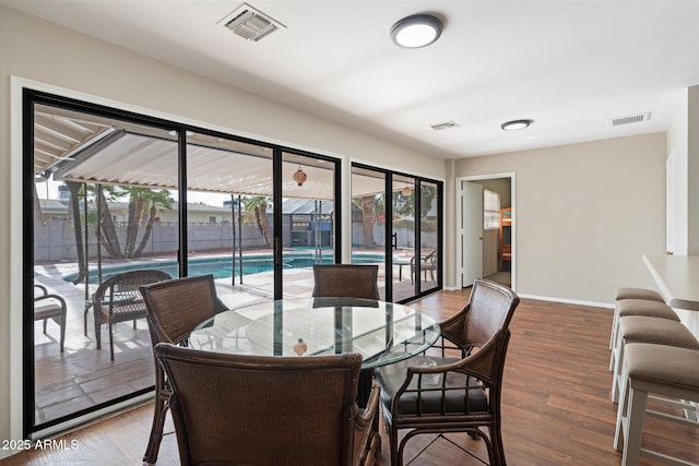 dining area featuring hardwood / wood-style floors and plenty of natural light