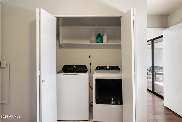 clothes washing area featuring separate washer and dryer and wood-type flooring