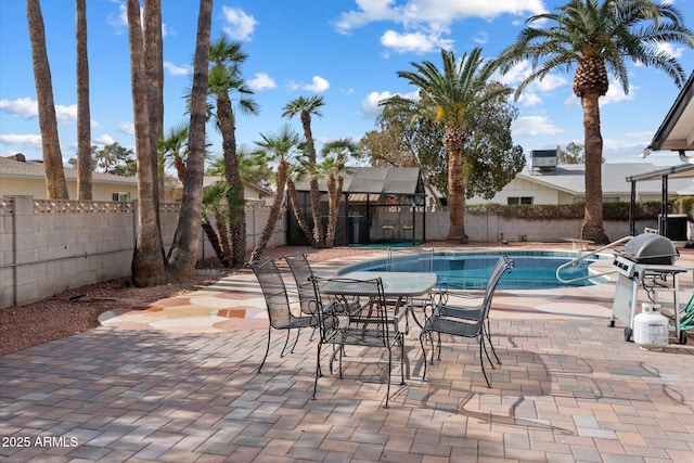 view of swimming pool with a grill and a patio