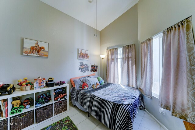 bedroom featuring high vaulted ceiling, multiple windows, and light tile patterned floors