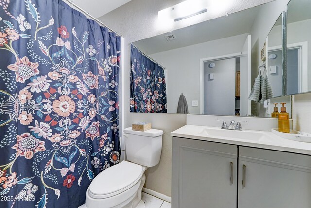 bathroom featuring visible vents, tile patterned flooring, vanity, curtained shower, and toilet