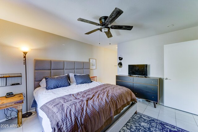 bedroom with ceiling fan and light tile patterned flooring