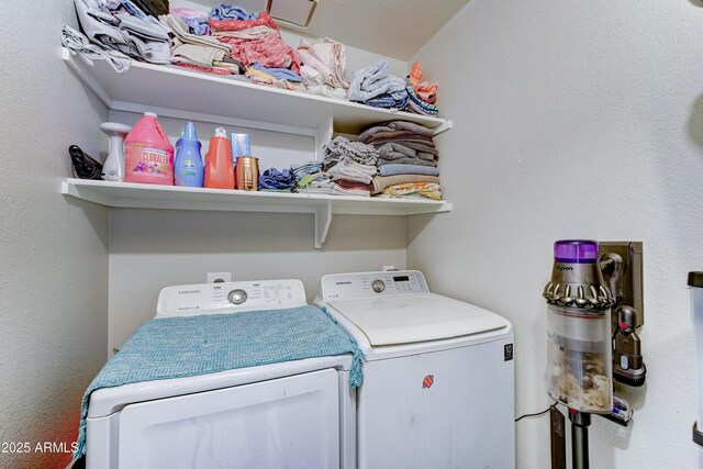 washroom with washing machine and clothes dryer and laundry area