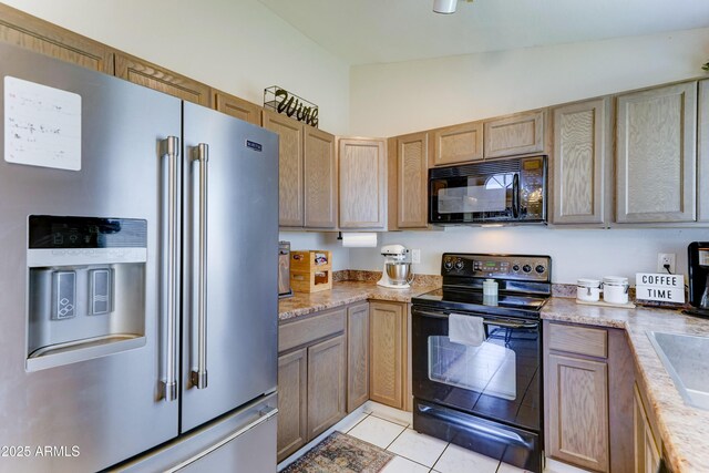 kitchen featuring black appliances and light tile patterned flooring
