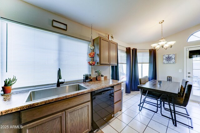 kitchen featuring pendant lighting, dishwasher, a sink, light tile patterned floors, and an inviting chandelier