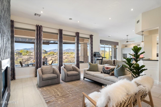 living room with a mountain view, recessed lighting, and visible vents