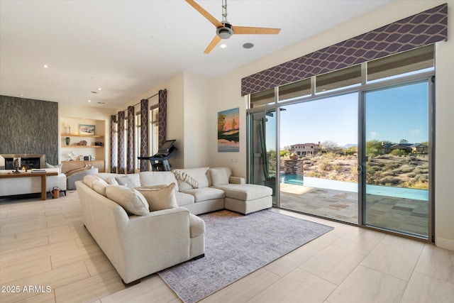 living room with recessed lighting, a fireplace, and ceiling fan