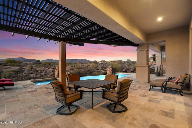 view of patio featuring a mountain view, fence, a fenced in pool, and a pergola