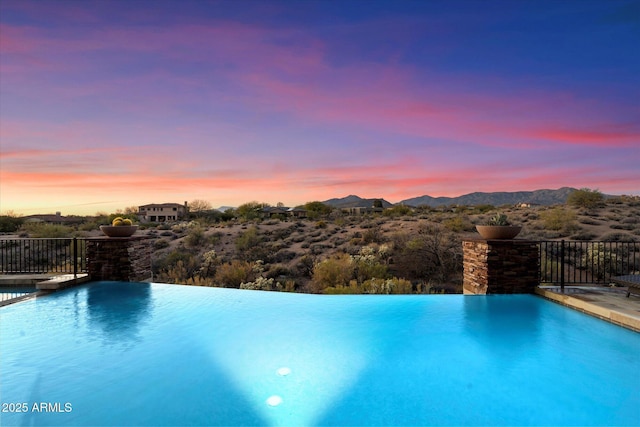 view of swimming pool featuring a mountain view and an infinity pool