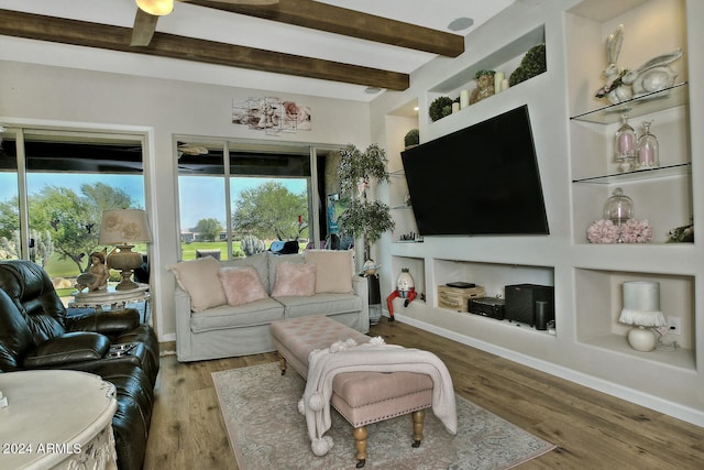 living room featuring beamed ceiling, hardwood / wood-style flooring, and ceiling fan