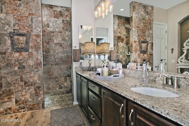 bathroom featuring vanity, a shower, and hardwood / wood-style flooring