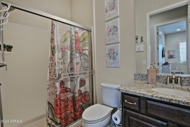 bathroom featuring vanity, toilet, and walk in shower