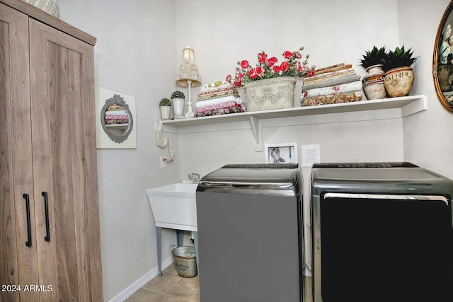 laundry room with washer and dryer, sink, and light tile patterned flooring