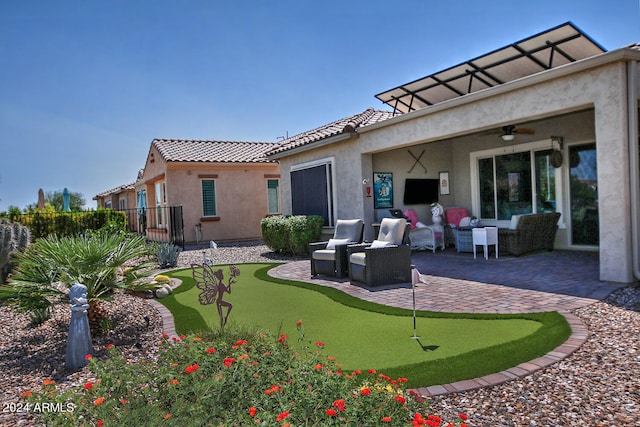 back of house featuring a patio and an outdoor hangout area