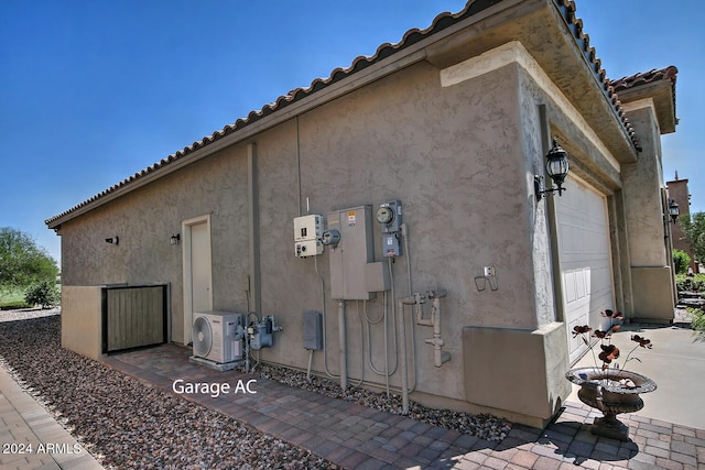 view of side of property with ac unit