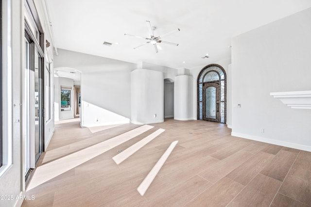 1724 W Blue Ridge Way, Chandler, AZ 85248 - foyer entrance featuring arched walkways, ceiling fan, light wood-style floors, and baseboards