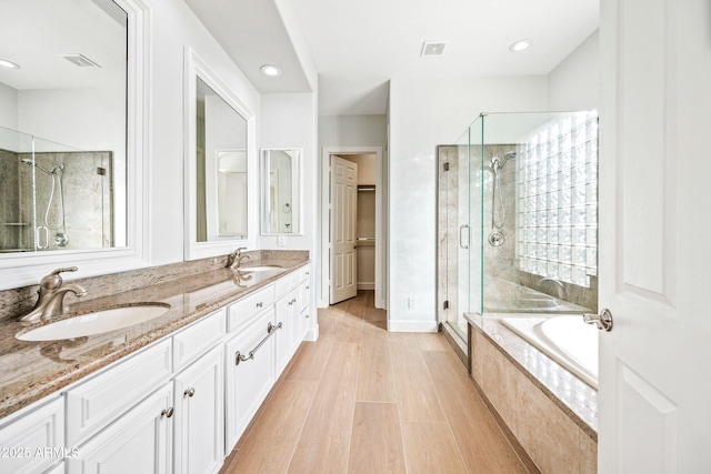 1724 W Blue Ridge Way, Chandler, AZ 85248 - full bathroom featuring a shower stall, a bath, double vanity, recessed lighting, and wood finished floors