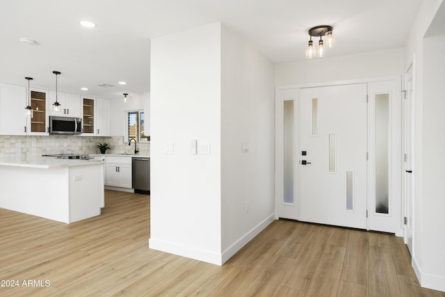 entrance foyer with light wood-type flooring, baseboards, and recessed lighting