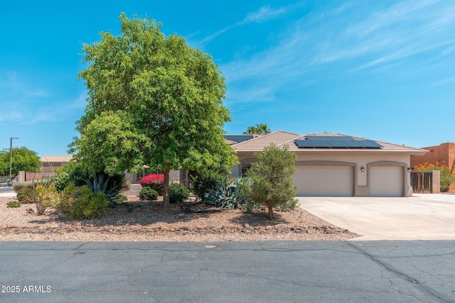 13034 W Krall Ct, Glendale, AZ 85307 - view of front of property featuring solar panels, concrete driveway, a garage, stucco siding, and a tiled roof