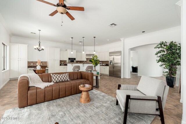 13034 W Krall Ct, Glendale, AZ 85307 - living room featuring ceiling fan, arched walkways, a chandelier, and ornamental molding