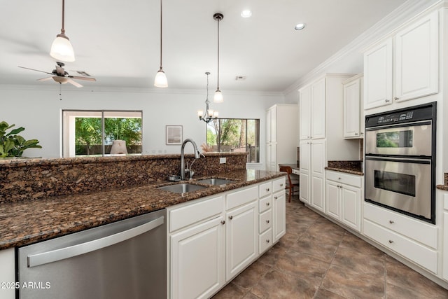13034 W Krall Ct, Glendale, AZ 85307 - kitchen featuring stainless steel appliances, crown molding, white cabinets, pendant lighting, and ceiling fan