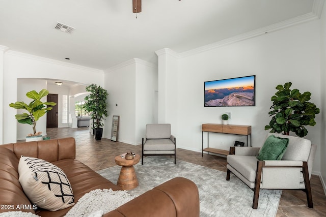 13034 W Krall Ct, Glendale, AZ 85307 - living area featuring arched walkways, crown molding, ceiling fan, and tile patterned floors