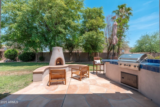 13034 W Krall Ct, Glendale, AZ 85307 - fenced backyard featuring a lit fireplace, a patio, and area for grilling