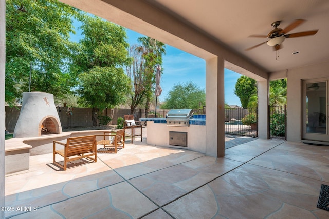 13034 W Krall Ct, Glendale, AZ 85307 - fenced backyard with a lit fireplace, area for grilling, a patio area, and a ceiling fan