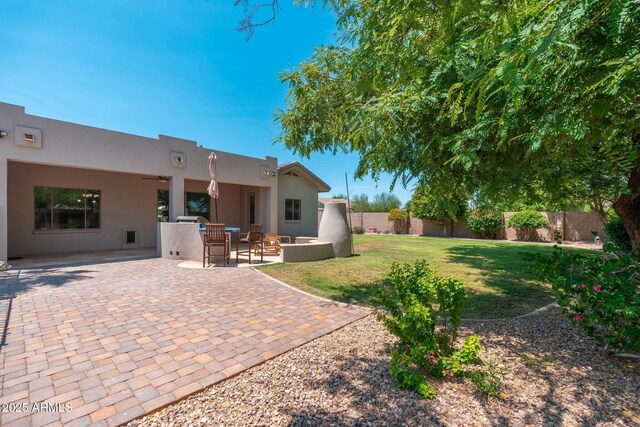 13034 W Krall Ct, Glendale, AZ 85307 - rear view of property featuring a fenced backyard, stucco siding, a patio area, and ceiling fan