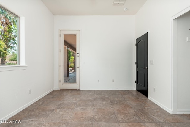 13034 W Krall Ct, Glendale, AZ 85307 - unfurnished room with healthy amount of natural light, stone finish flooring, and a smoke detector