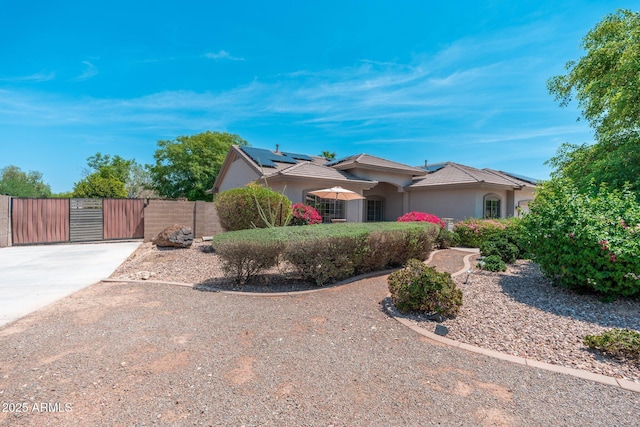 13034 W Krall Ct, Glendale, AZ 85307 - view of front facade featuring a gate, stucco siding, solar panels, and a tiled roof