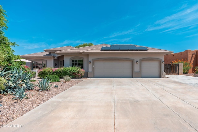 13034 W Krall Ct, Glendale, AZ 85307 - ranch-style house with concrete driveway, an attached garage, stucco siding, roof mounted solar panels, and a tiled roof