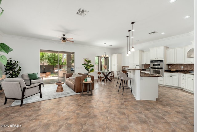 13034 W Krall Ct, Glendale, AZ 85307 - living room with ceiling fan, crown molding, recessed lighting, and a chandelier