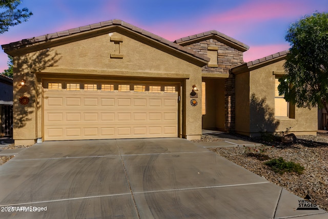 4548 E Carob Dr, Gilbert, AZ 85298 - view of front of house with driveway, stucco siding, a tile roof, and an attached garage