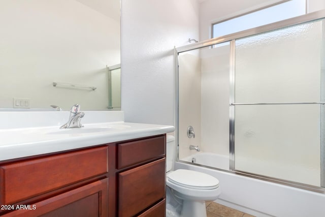 4548 E Carob Dr, Gilbert, AZ 85298 - bathroom with vanity, toilet, bath / shower combo with glass door, and tile patterned flooring