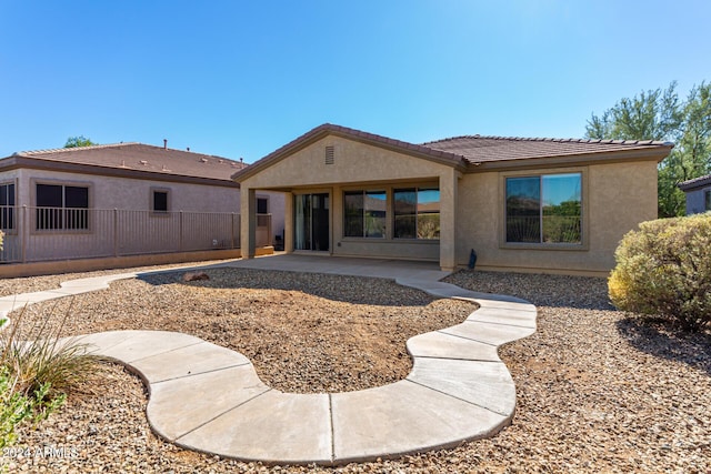 4548 E Carob Dr, Gilbert, AZ 85298 - back of property with a tiled roof, stucco siding, a patio, and fence