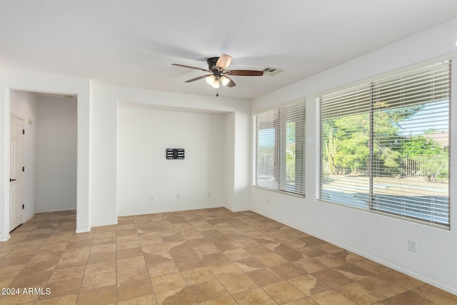 4548 E Carob Dr, Gilbert, AZ 85298 - spare room featuring a ceiling fan and baseboards