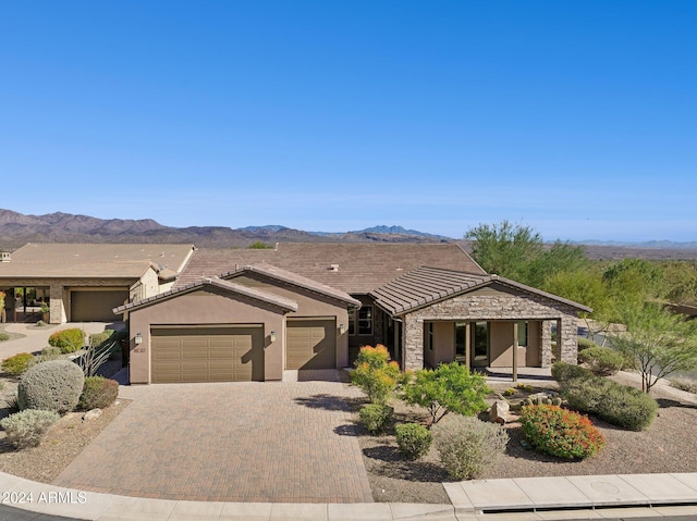 view of front of house featuring a garage and a mountain view