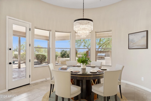 tiled dining area with a chandelier and a wealth of natural light