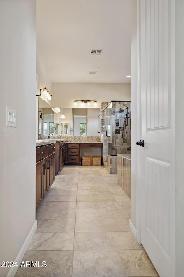 bathroom featuring vanity and a shower with door