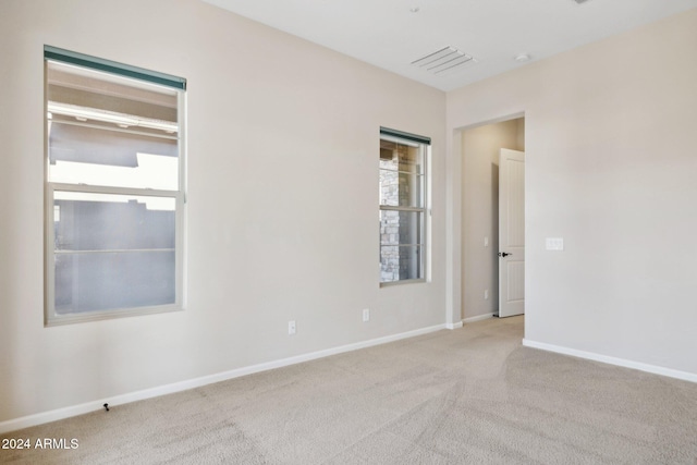 carpeted spare room with a healthy amount of sunlight