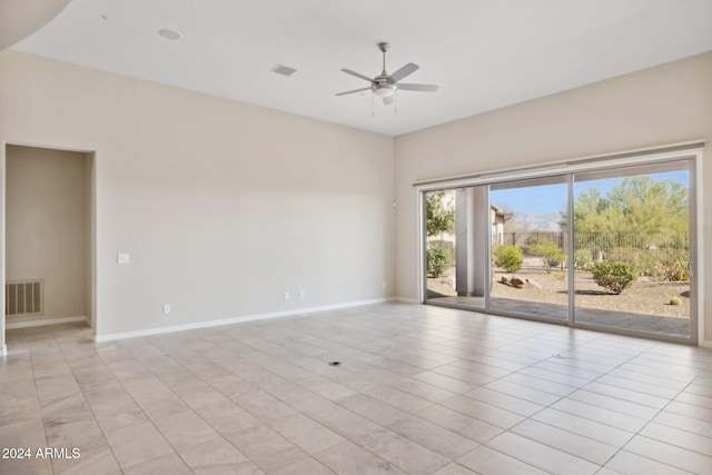 tiled empty room with ceiling fan