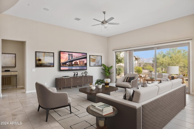 tiled living room featuring ceiling fan