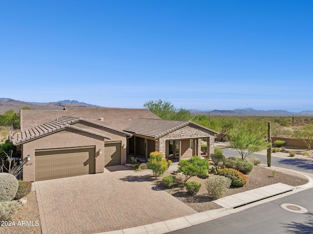 ranch-style house with a mountain view and a garage